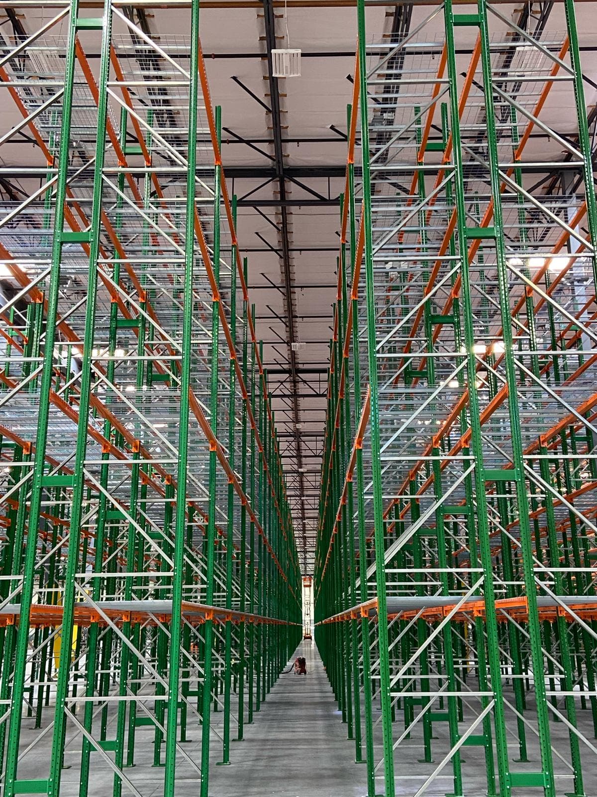 Vanishing-point aisle view through tall pallet rack installation