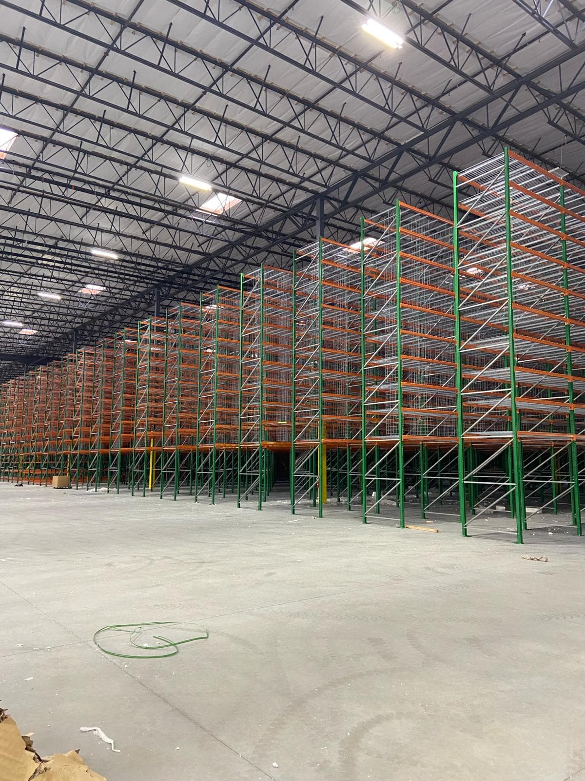 Selective pallet rack system with wire decking in a large warehouse